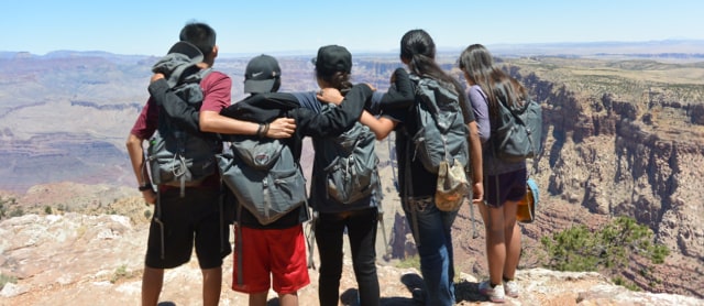 Picture of people standing in front of the Grand Canyon.